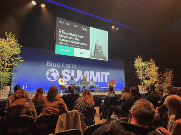 Panelists speaking on stage at Blue Earth Summit