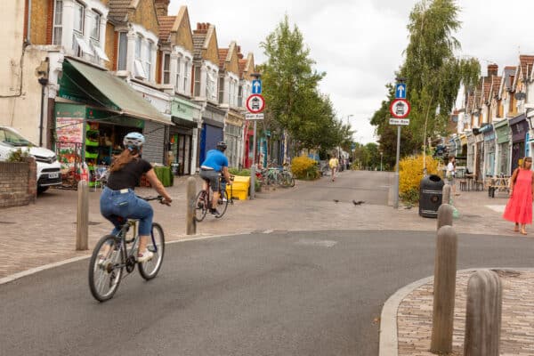 Cyclists travel down Francis Road where car travel is restricted in Walthamstow